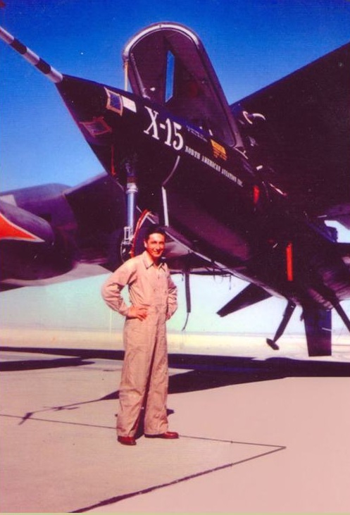 Test pilot Albert Scott Crossfield with X-15 56-6670 attached to the right wing pylon of NB-52A 52-003 at Edwards Air force Base. (North American Aviation Inc.)