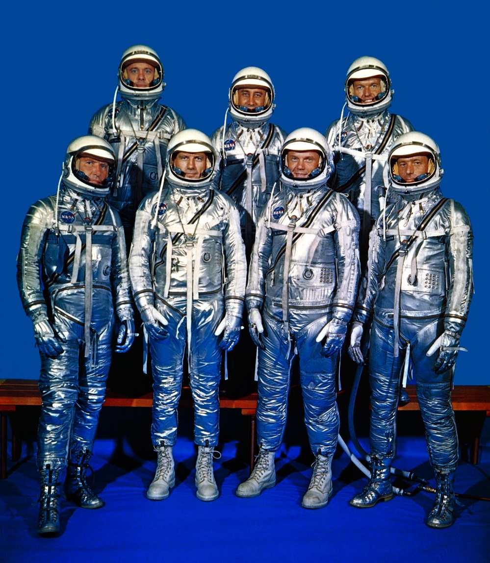 The Mercury 7: Front row, left to right, LCDR Walter Marty Schirra, USN; CAPT Donald Kent Slayton, USAF; LCOL John Herschel Glenn, Jr., USMC; LT Malcolm Scott Carpenter, USN. Back row, left to right, LCDR Alan Bartlett Shepard, Jr., USN; CAPT Virgil Ivan Grissom, USAF; CAPT Leroy Gordon Cooper, Jr., USAF. (NASA)
