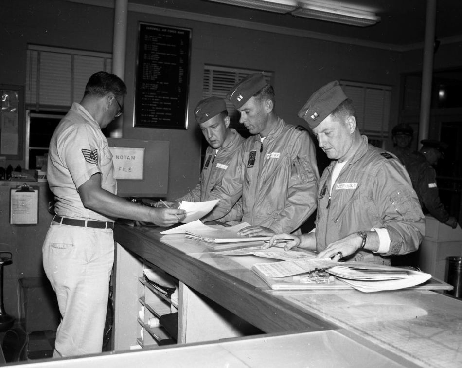 The crew of Cowtown Hustler checks the weather and files their flight plan at Carswell Air Force Base, Texas, before taking off on Operation Heat Rise, 5 March 1962. (U.S. Air Force) 