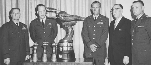 The crew of Cowtown Hustler is presented the Bendix Trophy by A.P. Fontaine of the Bendix Corporation. Left to right, Sowers, MacDonald, Walton, Fontaine and Crew Chief, Master Sergeant Cockrell.