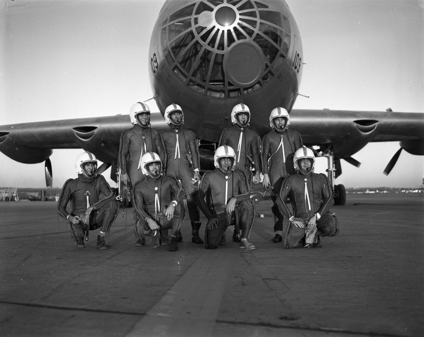 Crewmebers pose in front of a B-36F, wearing capstan-type partial pressure suites for protection at high altitude. Front (L-R): G.L. Whiting, B.L. Woods, I.G. Hanten, and R.L. D’Abadie. Back (L-R):A.S. Witchell, J.D. McEachern, J.G. Parker and R. D. Norvell. (Jet Pilot Overseas)