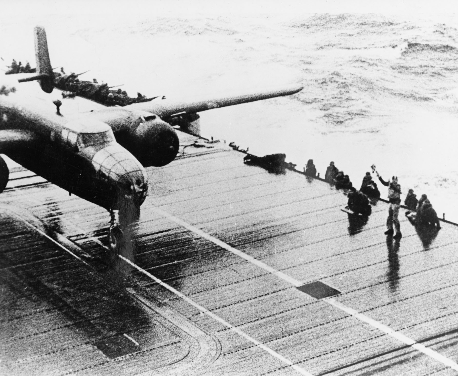 A North American Aviation B-25B Mitchell medium bomber revs its engines, awaiting teh signal to launch from the flight deck officer. (U.S. Air Force)