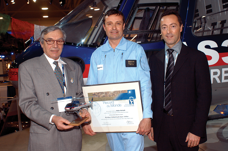 FAI representatve (left) presents a World Record certificate to Eurocopter test pilot Didier Delsalle while company CEO looks on. (Aviation International News)