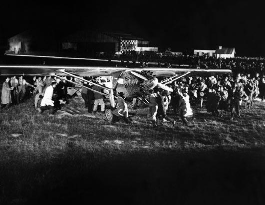 Crowds approach Charles Lindbergh an dteh Spirit of St. Louis at Le Bourget, shortly after landing, 21 May 1927.(Keystone-France/Gamma-Keystone/Getty Images)