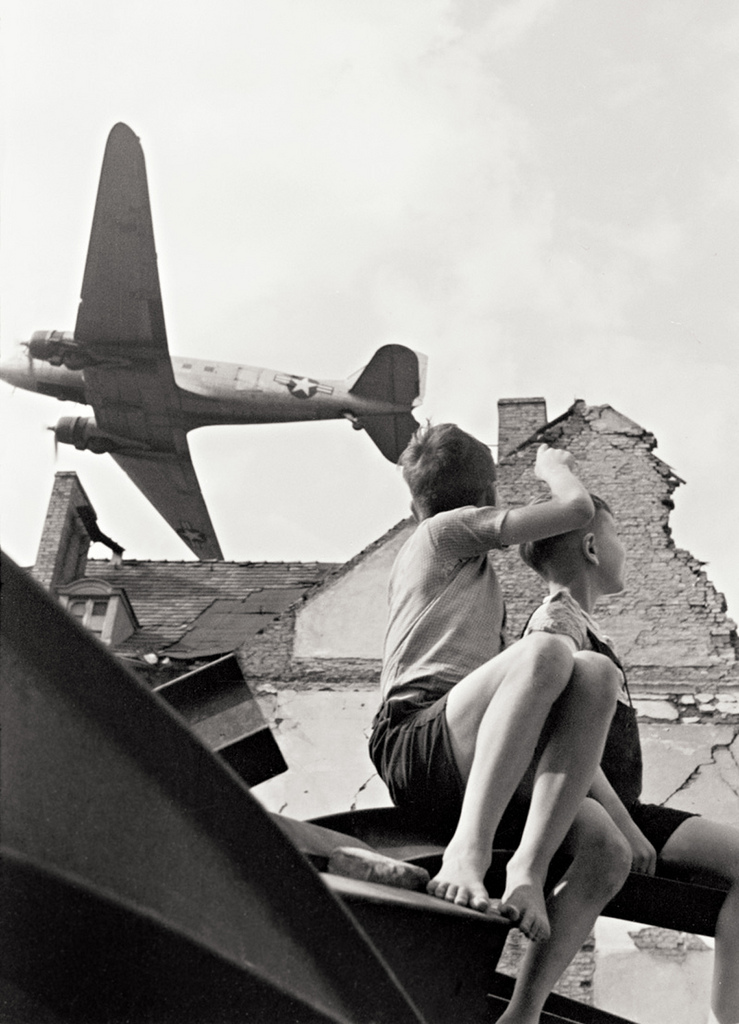 A Douglas C-47 Skytrain clears the rooftops after takeoff from Berlin-Templehof. (Unattributed)