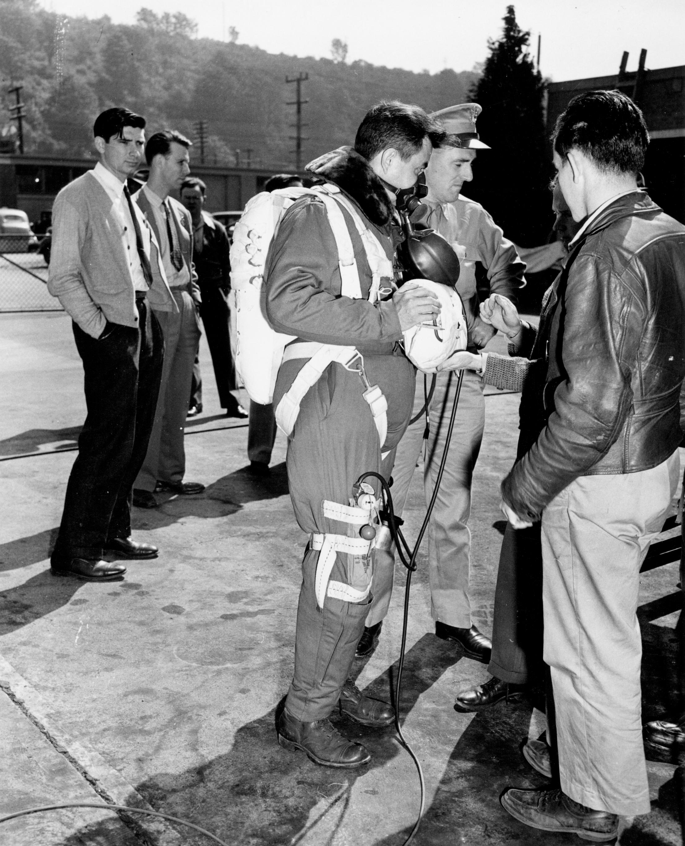 Lieutenant Colonel William R. Lovelace II, M.D., Medical Corps, United States Army, wearing a pressure mask, oxygen bottle an parachute, prior to teh high-altitude jump, 24 June 1943. (Lovelace Respiratory Research Insititute)