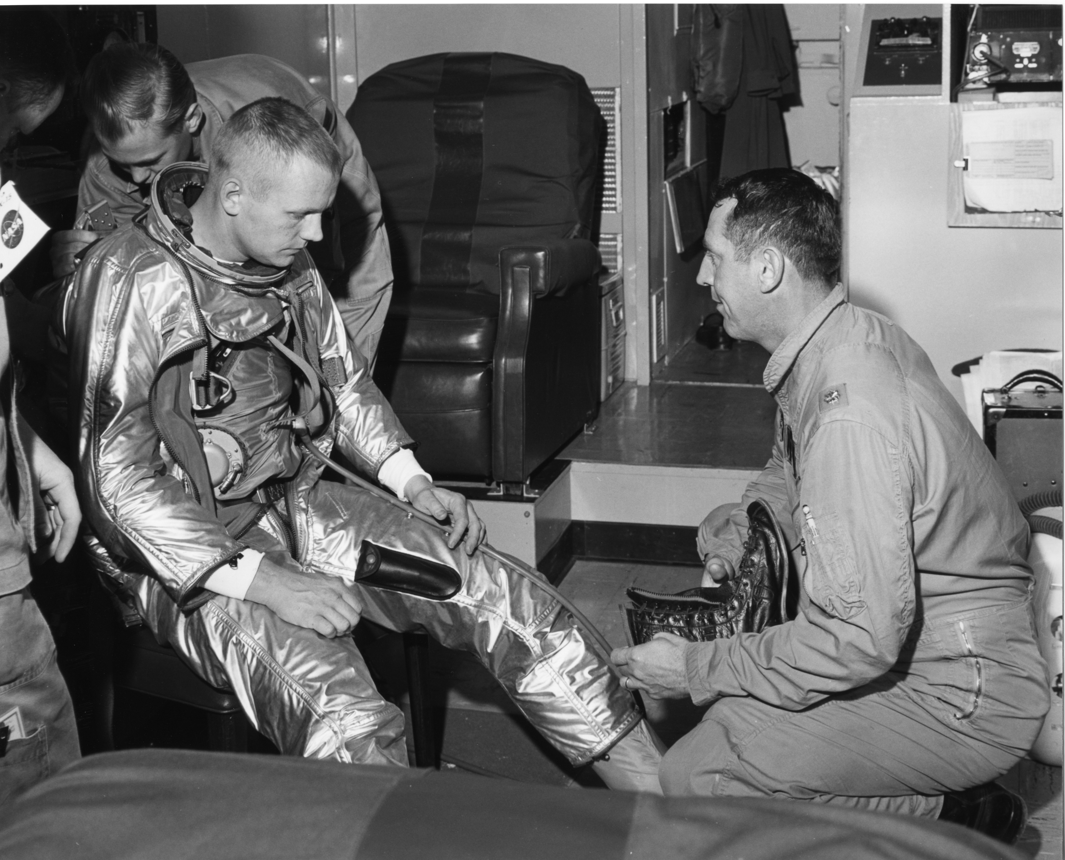 NASA test pilot Neil A. Armstrong dons a pressure suit before his first flight in teh North American Aviation X-15 hypersonic research rocketplane, at Edwards AFB, 30 November 1960. (NASA)