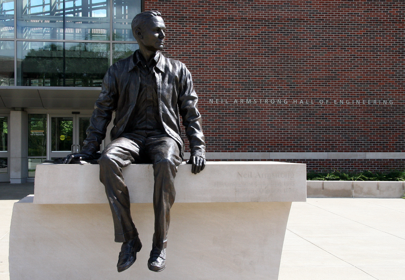 A bronze statue of Neil Alden Armstrong in front of the Hall of Engineering.