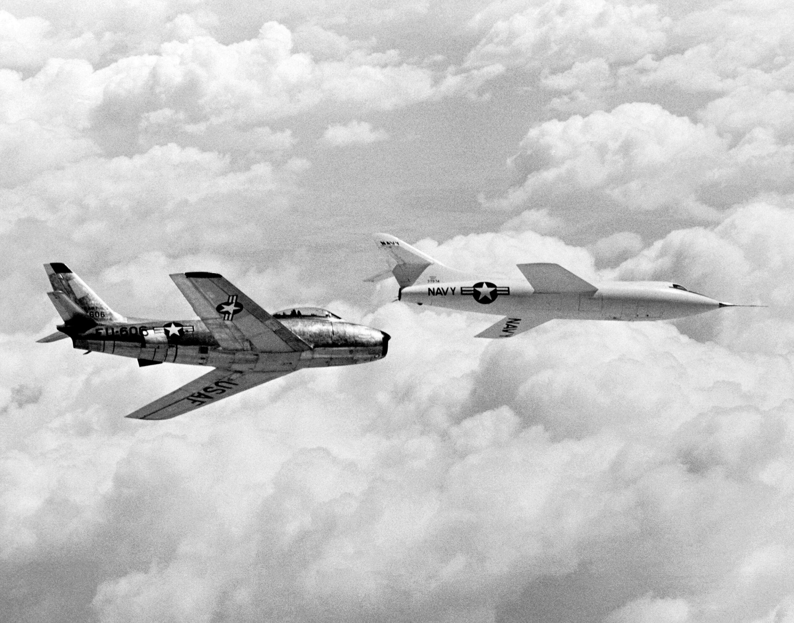 A Douglas D-558-II Skyrocket, Bu. No. 37974. glides back toward Rogers Dry Lake at Edwards Air force Base. A North American Aviation F-86E-1-NA Sabre, 50-606, flies chase. Major Charles E. "Chuck" Yeager frequently flew as a chase pilot for both Bill Bridgeman and Scott Crossfield. (NASA) 