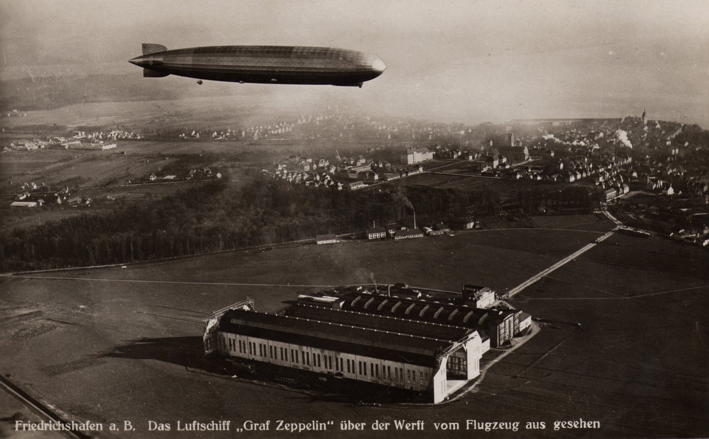 Graf Zeppelin over the airship hangars at Firedrichshafen. (The Lothians collection) 