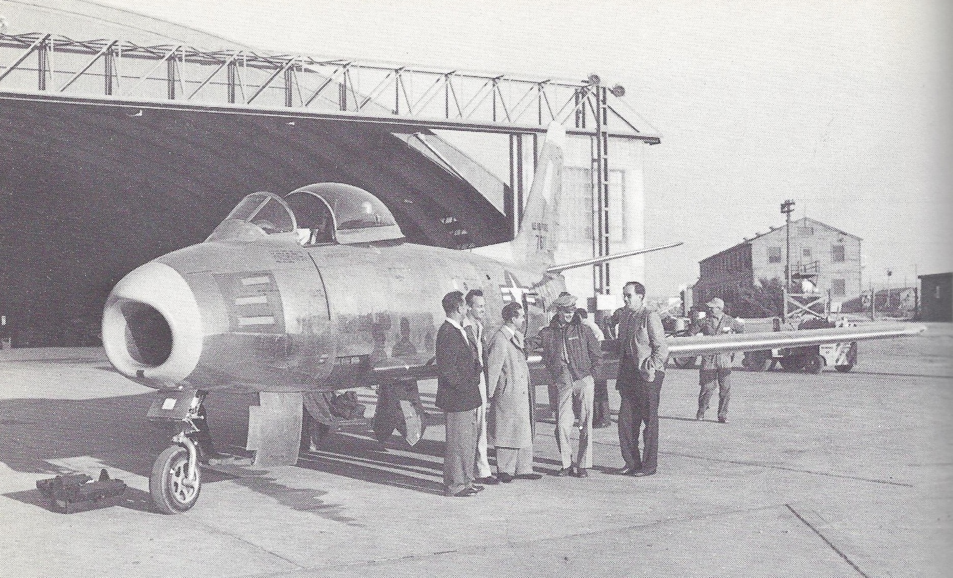 Major Richard L Johnson, USAF with F-86A-1-NA 47-611 and others at Muroc AFB, 15 September 1948. Note the gun port doors on this early production aircraft. They opened in 1/20 second as the trigger was pressed. Proper adjustment was complex and they were soon eliminated. (Image from F-86 SABRE, by Maurice Allward, Charles Scribner’s Sons, New York, 1978, Chapter 3 at Page 24.)