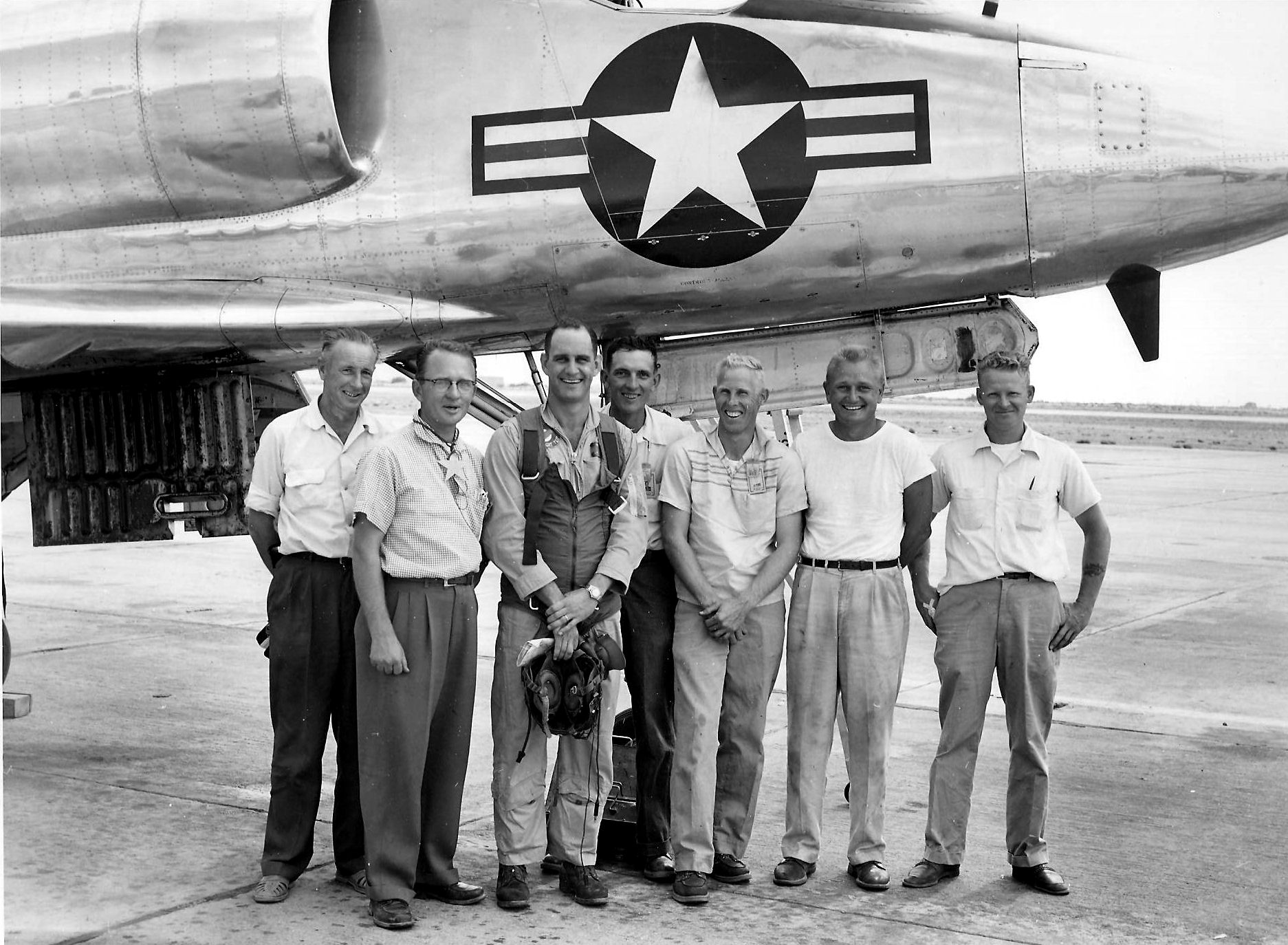 Lieutenant Gordon L. Gray, Jr., U.S. Navy (thrid from left) with the Douglas Aircraft Company A4D team at Edwards AFB, California, 15 October 1955. (Navy Pilot Overseas)