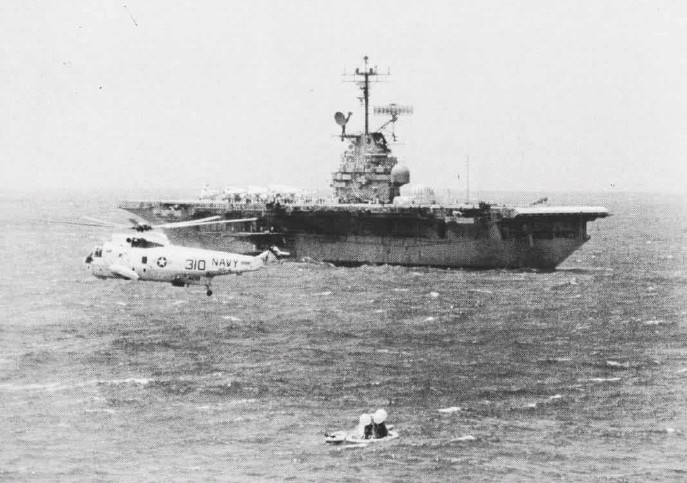 Apollo 12 command module Yankee Clipper splashed down within approximately 2.5 nautical miles of the primary recovery ship. It is in the foreground of this photograph, with a Sikorsky SH-3D Sea King and USS Hornet (CVS-12), approximately 11:00 a.m., local time, 24 November 1969. (U.S. Navy)