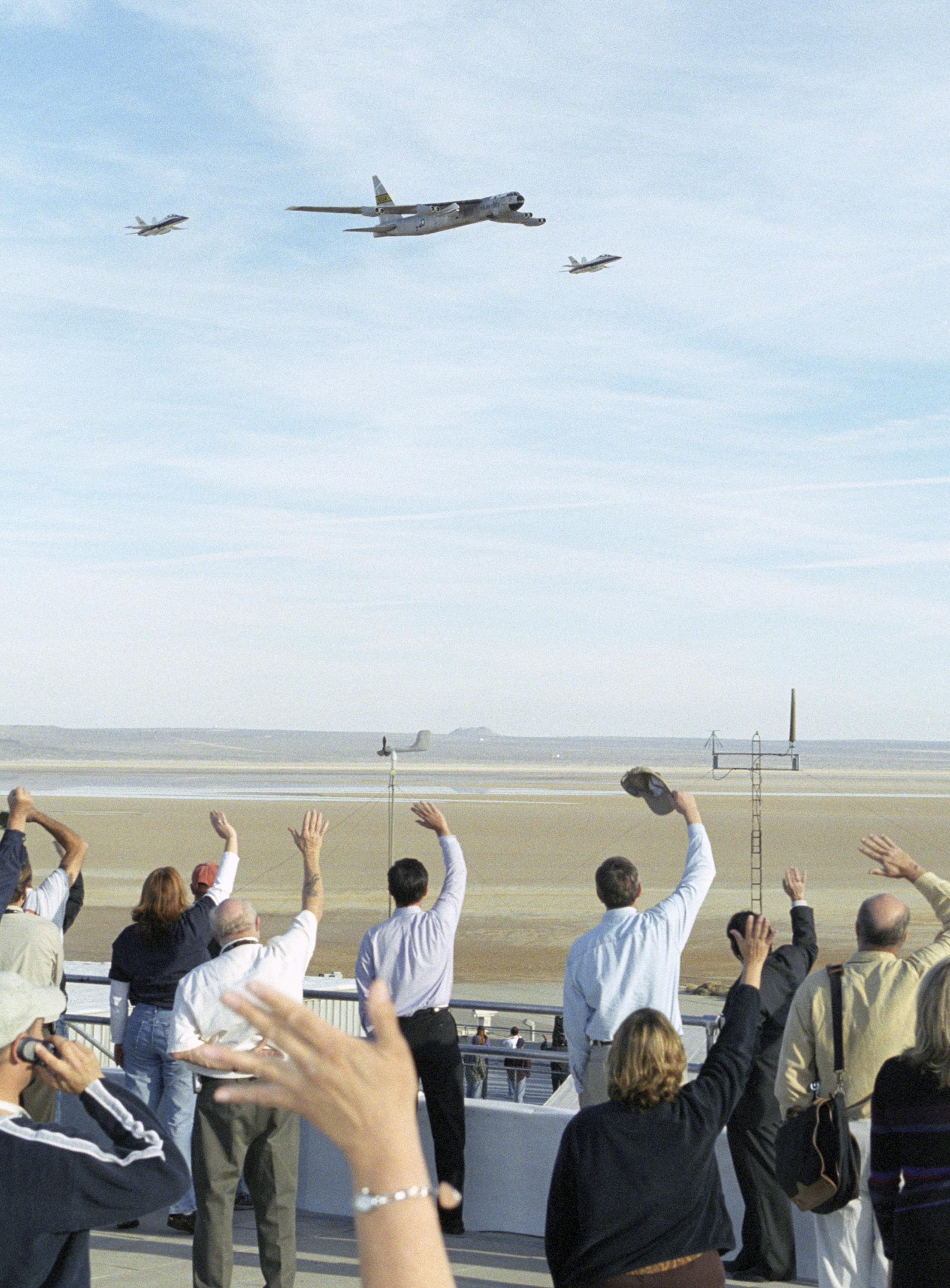 Boeing NB-52B Stratofortress 52-008, Balls 8, escorted by two NASA F-18 chase planes, performs a farewell flyover during its final flight, 16 November 2004. (NASA)