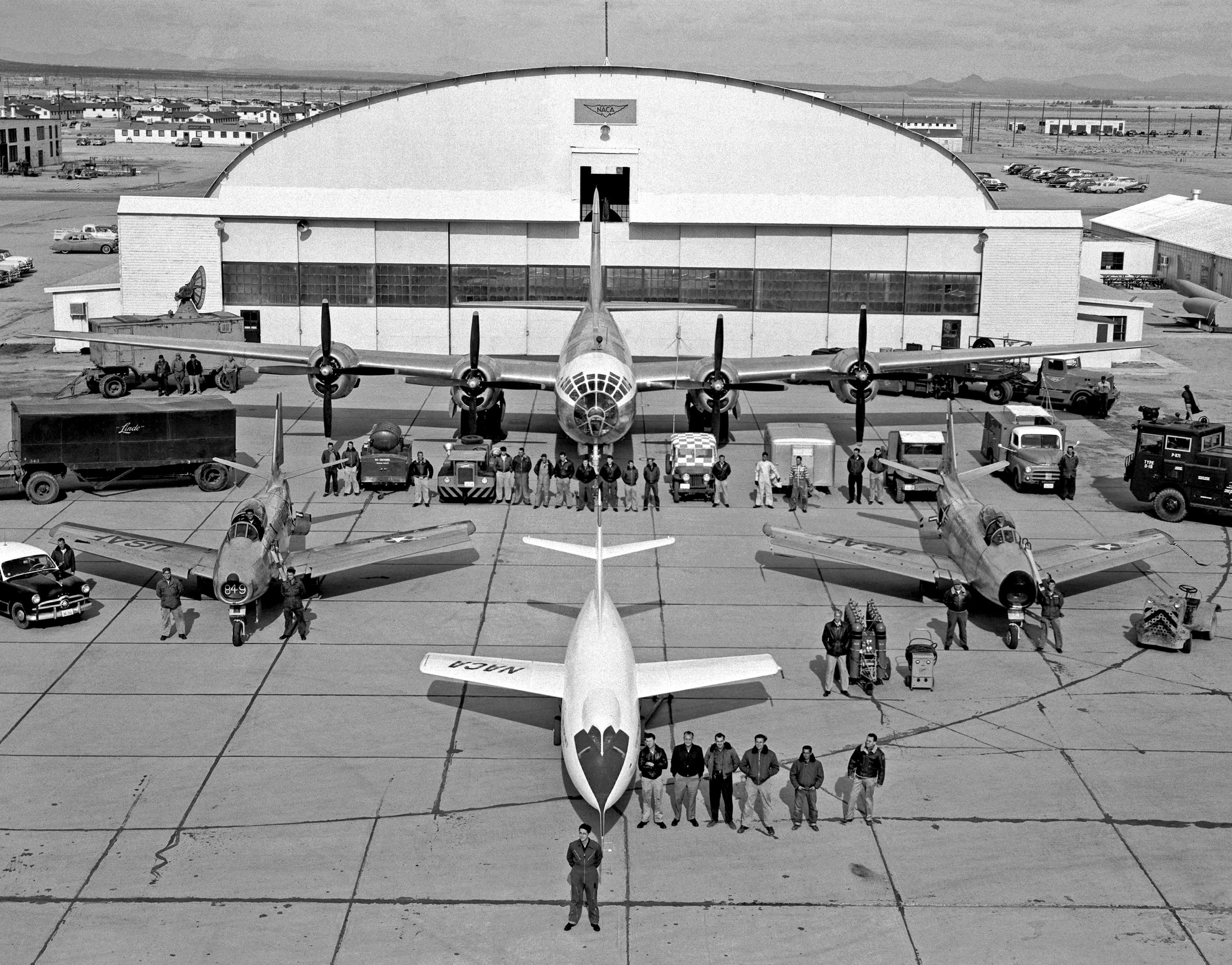 Scott Crossfield and the Douglas D-558-II Skyrocket, with their support team: two North American F-86 Sabre chase planes and the Boeing P2B-1S Superfortress mothership, at the NACA High Speed Flight Station, Edwards Air Force Base, California, 1 January 1954. (NASA)