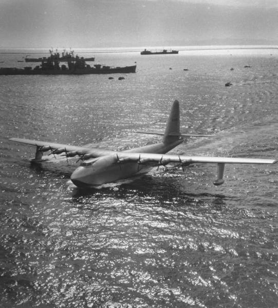 Hughes H-4 Hercules NX37602 in San Pedro Bay, 2 November 1947. Two U.S. Navy heavy cruisers and a fleet oiler are in the background. On the horizon is Santa Catalina Island, "Twenty-six miles across the sea...." (LIFE Magazine)