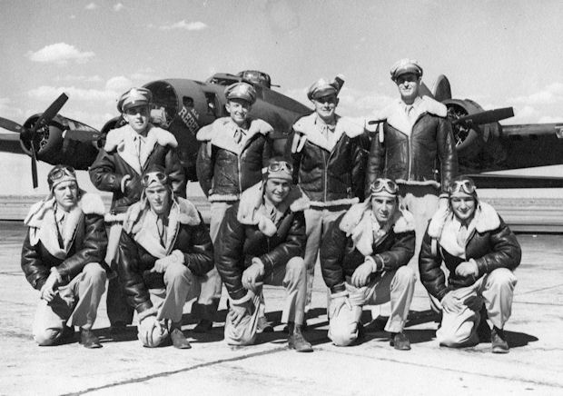 358th Bombardment Squadron flight crew. Most of the men in this photograph were aboard "Jersey Bounce Jr.", 20 December 1943. Front, left to right: Sgt. Edward Ruppel. ball turret gunner; T/Sgt. Forest L. Vosler, radio operator; S/Sgt. William H. Simpkins, Jr., flight engineer/top turret gunner; Sgt. Gratz, tail gunner 9replaceing teh critically wounded Sgt. George W. Burke, who was rescued by Vosler); Sgt. Raaplh F. Burkhart, waist gunner. Rear, left to right: 2nd Lt. Warren S. Wiggins, navigator; 2nd Lt. Woodrow W. Monkres, bombardier; 2 Lt. Walter J. Ames, co-pilot; 2nd Lt. John F. Henderson, aircraft commander. (U.S. Air Force) 