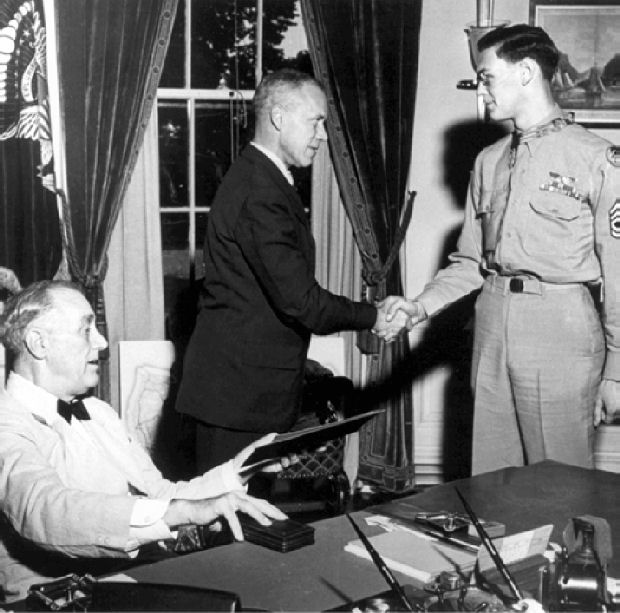 Technical Sergeant Forrest L. Vosler, United States Army Air Corps, is awarded the Medal of Honor by President Franklin Delano Roosevelt in a ceremony in the Oval Office of the White House, Washington, D.C. (U.S. Air Force)
