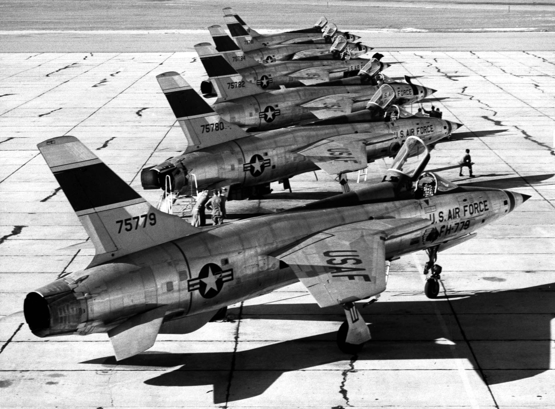 Six F-105B-10-REs (6 of 9 block 10 aircraft built) of General Moore's 4th Tactical Fighter Wing parked on the ramp. The stripes on the nose and vertical fin are green. Aircraft are (nearest to farthest) S/N 57-5779, -5780, -5782, -5784, -5781, -5778. (U.S. Air Force photo)