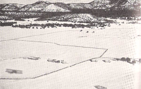 At the lower left corner of this image, the shadow of a Curtiss B-2 Condor can be seen as it prepares to drop supplies at the Navajo reservation near Winslow, Arizona, 17 January 1932. (Davis-Monthan Aviation Field Register) 