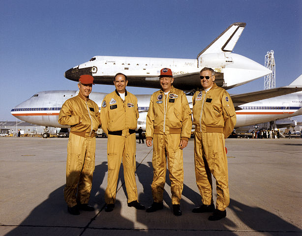 This photograph shows the crew of the Shuttle Carrier Aircraft, NASA 905, in 1981: From left, they are, Tom McMurty, pilot; Vic Horton, flight engineer; Fitz Fulton, command pilot; and Ray Young, flight engineer (replacing Guidry). The Space Shuttle Columbia is attached to NASA 905. (NASA)