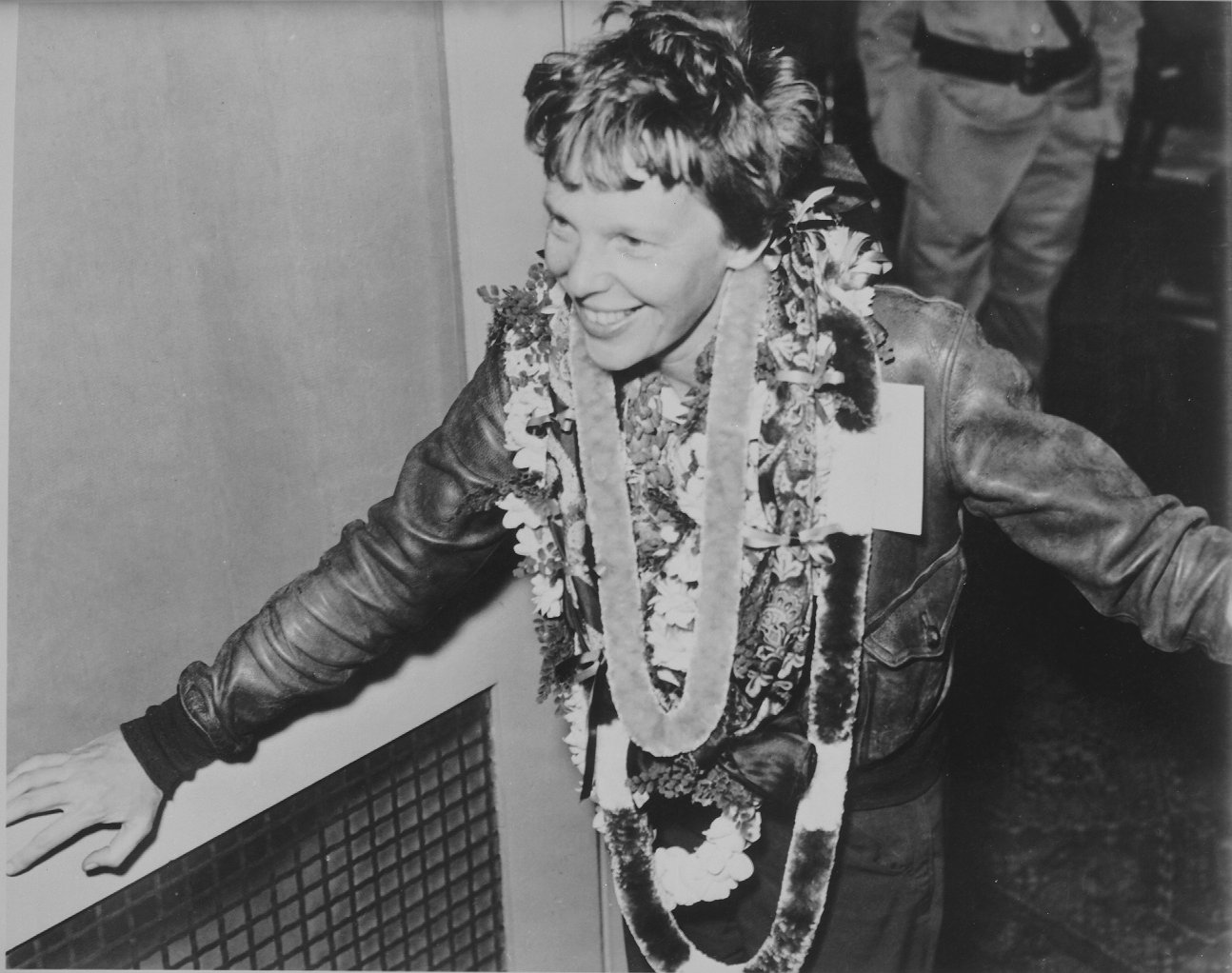 Amelia Earhart, with flower leis, on her arrival at Wheeler Field, Oahu, Territory of Hawaii, 18 March 1937. (Hawaii’s Aviation History http://hawaii.gov/hawaiiaviation)