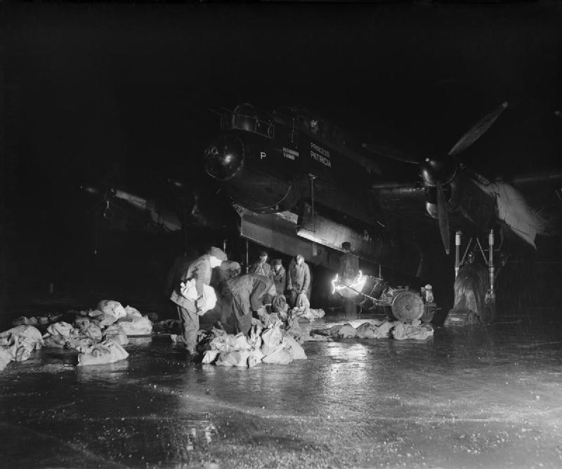 Royal Air Force Avro Lancaster Princess Patricia of No. 514 Squadron at RAF Waterbeach, Cambridgeshire, UK, being loaded with food for Operation Manna, 29 April 1945, (Pilot Officer Penfold, Royal Air Force official photographer)