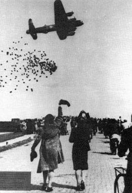 A Royal Air Force Avro Lancaster heavy bomber drops food packages over The Netherlands.