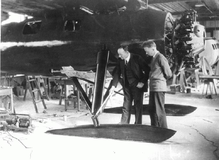 Hubert Wilkins and Ben Eielson examine the metal skis on their Lockheed Vega.
