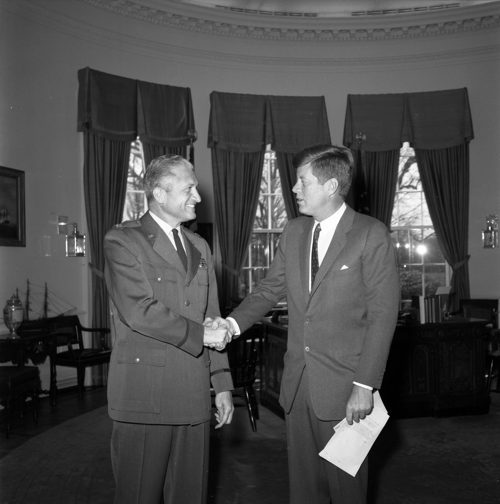 Colonel James B. Swindal, United States Air Force is congrtulated on his promotion by President John F. Kennedy. (Presidential Library)