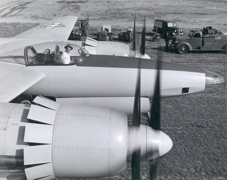 Howard Hughes in teh cocpit of the first prototype XF-11, 44-70155, with all propellers turning, at Culver City, California. (University of Nevada, Las Vegas Libraries) 