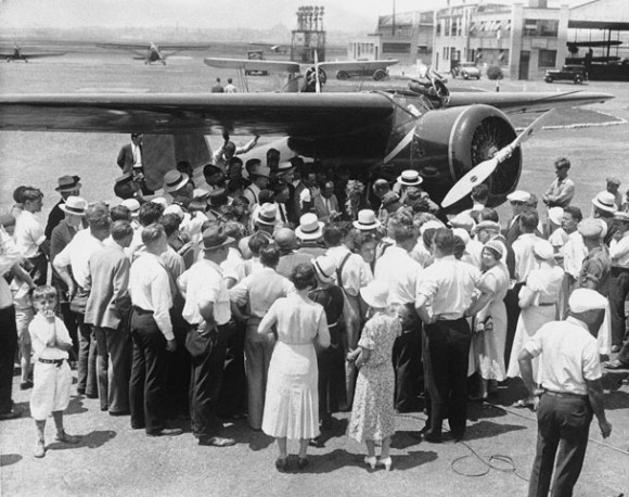 A small crowd gather's around Amelia Earhart an dher Lockheed Model 5B Vega at Newark Municpal Airport, 25 August 1932. (AP)