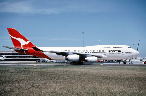 Boeing 747-438 Longreach VH-OJA, City of Canberra at Sydney, Australia, August 1989. The motto, WE FLY FURTHER has been painted on the fuselage in recognition of the new airliner's distance record. (John McHarg) 