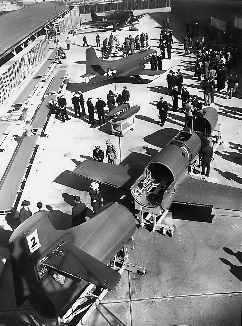 This photograph shows two of the three D-558-I Skystreaks being inspected by U.S. navy officials at the Douglas Aircraft Company plant. In the foreground is the number two aircraft, Bu. No. 37971, with the sections o fte hfuselage separted for better viewing. The entire nose section, including teh cockpit, coul dbe jettisoned in an emergency. The second aircraft is Bu. No. 37970, th eSkystrak flown by CDR Caldwell for his speed record. In the background is another Douglas airplane, the famous AD Skyraider. (Douglas Aircraft Company) 