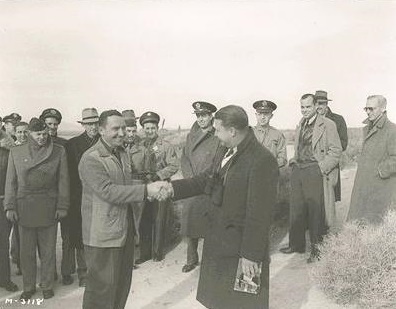 Milo Burcham, on the left, shakes hands with Clarence L. Johnson following the first flight of the Lockheed XP-80, 8 January 1944. (Lockheed) 