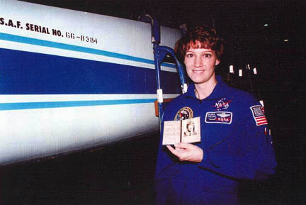 Astronaut Eileen Collins holds Bobbie Trout’s pilot certificate, 1995. (Unattributed)