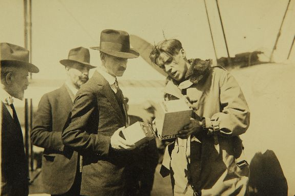 aeronautics officials check altitude-recording barographs with Roland Rohlfs after a record-setting flight. (San Diego Air and Space Museum Archives)