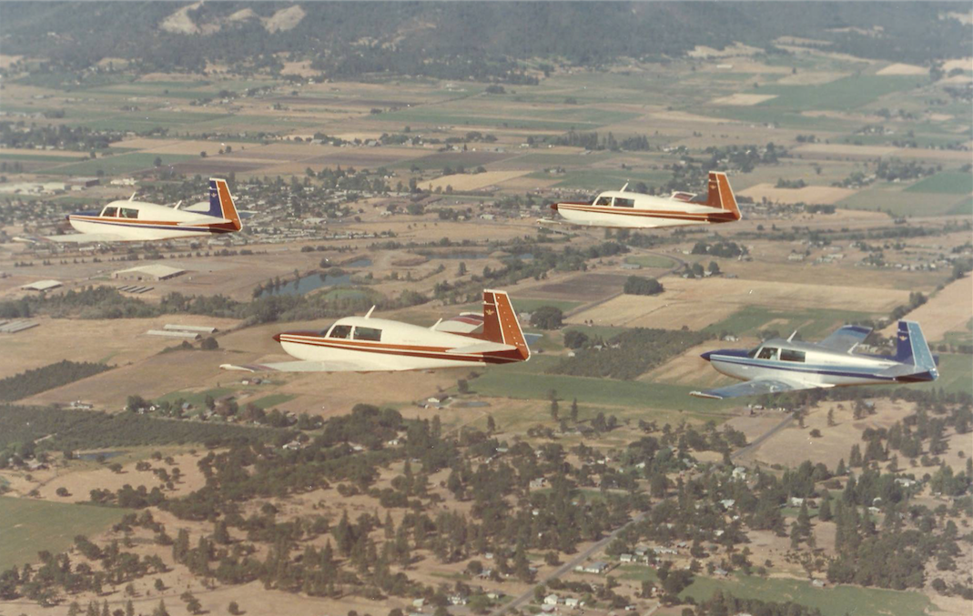 A flight of four Mooney M20Ks. The lead airplane is teh world and national record holder Mooney 231 N231LR. (Photograph courtesy of Al Gerharter)