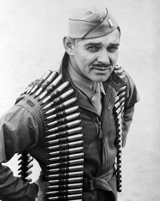 Lieutenant Clark Gable with a belt of linked .50-caliber machine gun cartridges.