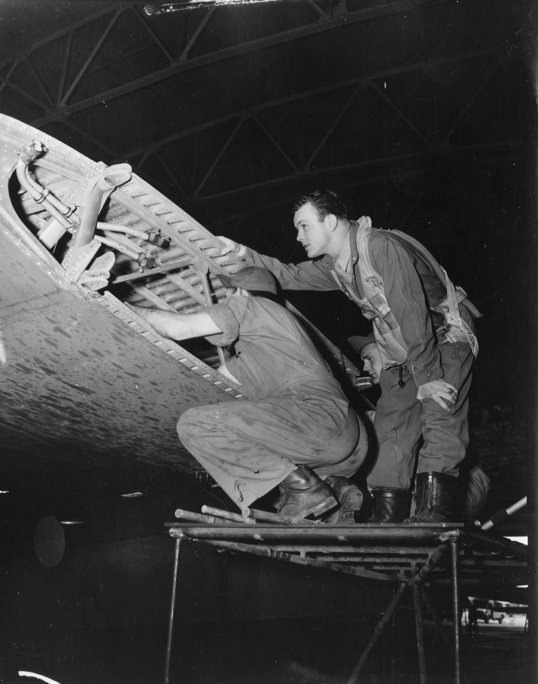 Major William R. Calhoun checks a repair on his B-17F bomber, The 8 Ball. (Planet News Ltd.)