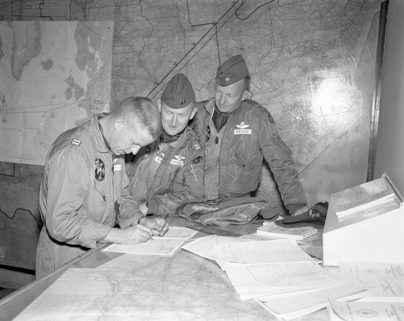 The flight crew of the Convair B-58A-10-CF Hustler 59-2451, "The Firefly," planning the Washington, D.C.-to-Paris flight, 26 May 1961. Left to right, Captain William L. Polhemus, Captain Raymond R. Wagener and Major William R. Payne. (Jet Pilot Overseas)