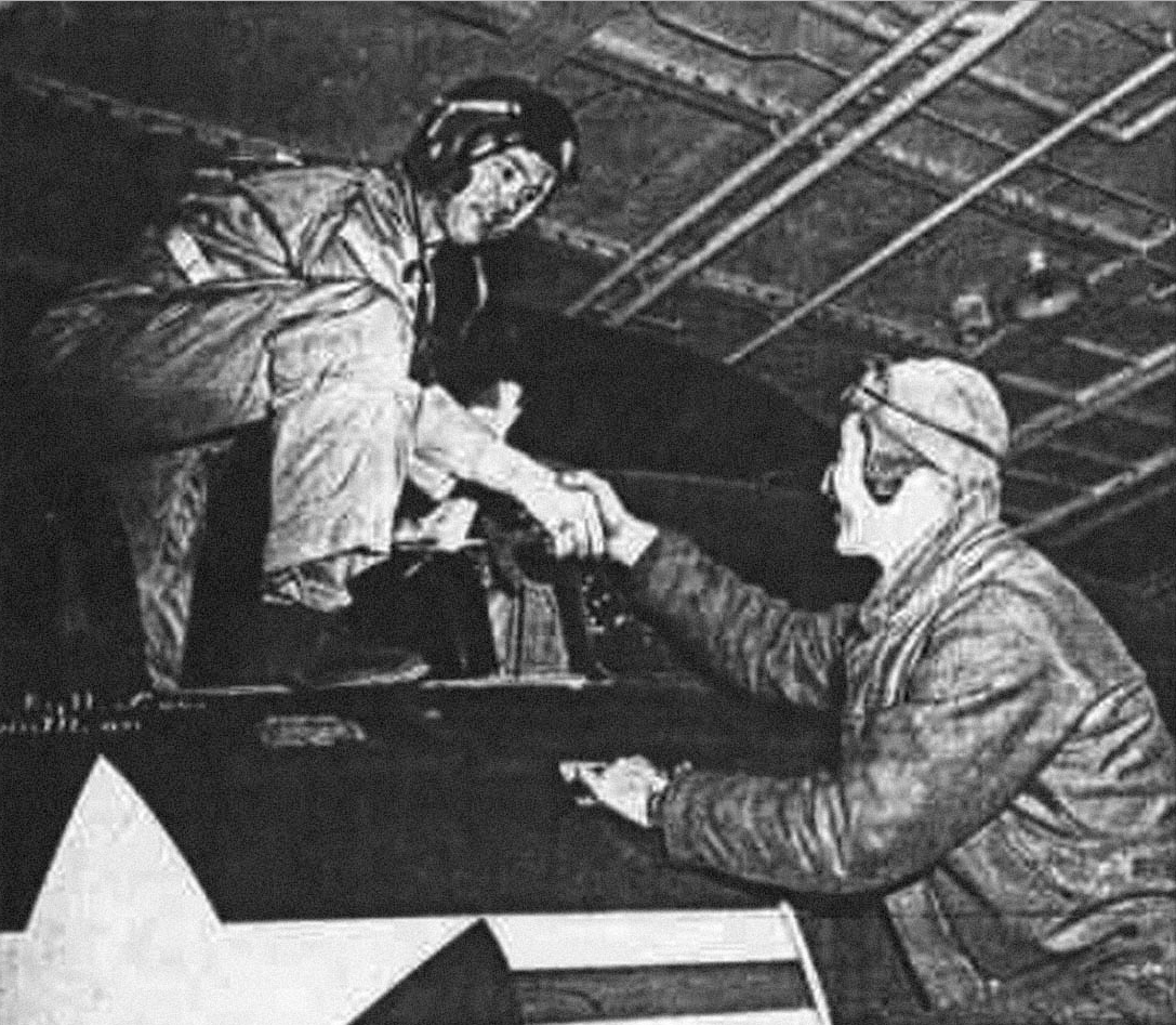 Lieutenant Commander William T. Amen, U.S. Navy, of squadron VF-111, is congratulated on his air to air victory after returning to the aircraft carrier USS Phillipine Sea (CV-47). (U.S. Navy)