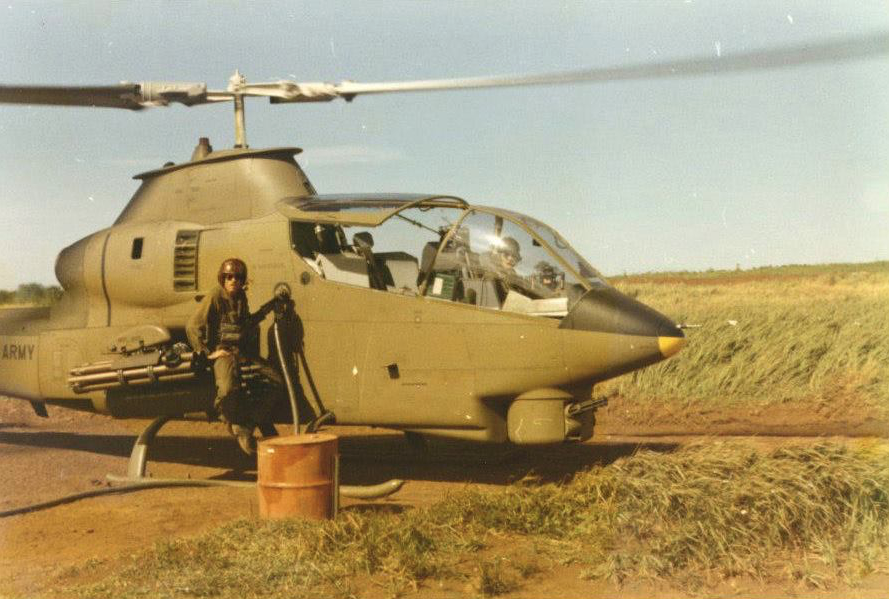 CW2 Jerry Boyle, Apache Troop, First of the Ninth, Air Cav, "hot refueling" (engine running, rotors turning) his Bell AH-1G Cobra attack helicopter, somewhere along the Cambodian border, circa 1971. Jerry is the aircraft commander; his seat in the rear cockpit is empty. 1st Lt. Jeff Cromar, Jerry's co-pilot and gunner, is in the forward cockpit.
