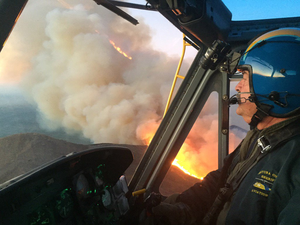 Deputy Sheriff Jim Miller Dalton, flies Copter 7 over the Solimar Fires, northwest of the City of Ventura just after sunrise, 26 Decmber 2015. Jim has been flying all night. (KABC) 