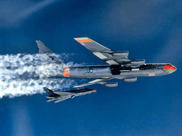 A North American Aviation F-100 Super Sabre chase plane follows NB-52A 52-003 prior to launch of an X-15. (NASA)