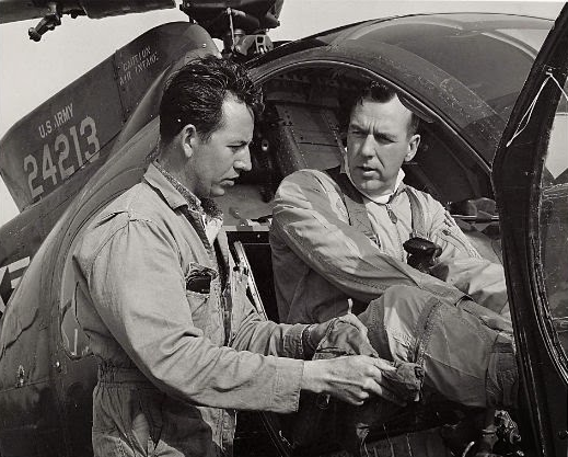 Test pilot Bob Ferry in teh cockpit of YOH-61 62-4213, with engineer Dick Lofland, before the non-stop coast-to-coast flight. (Hughes Aircraft)