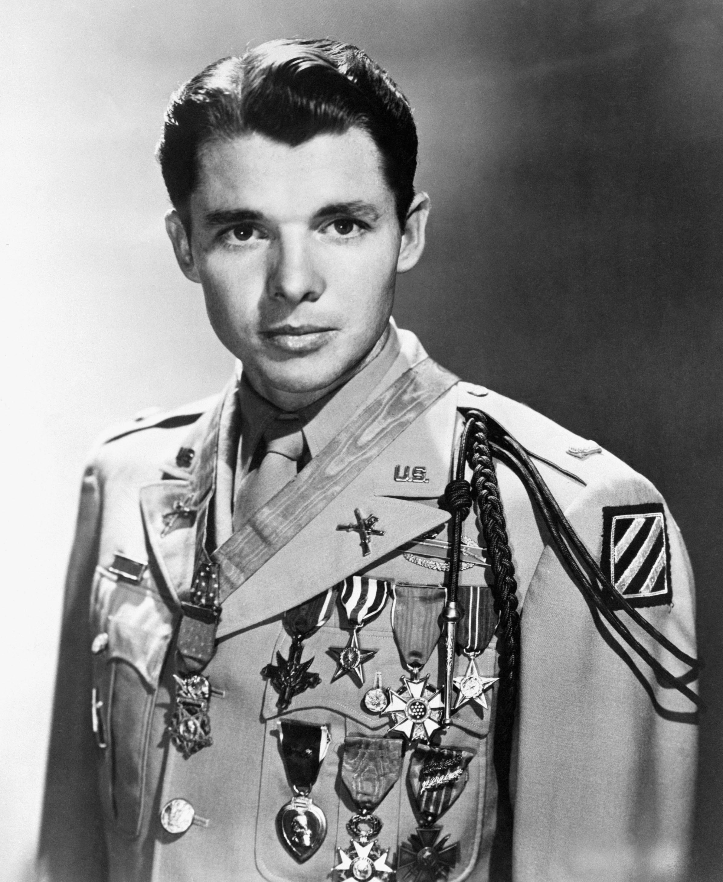 Original Caption: 1950-Film star Audie Murphy, World War II's most decorated hero, will train with Texas' famed 36th National Guard Infantry for possible action in Korea. Murphy received a Captain's commission of intelligence in 36th Division unit at Austin, TX., and will train with the Division at Fort Hood, TX. Murphy is officially credited with killing, capturing or wounding 240 Germans during World War II. He received a battle field commision as a lieutenant and every citation the Army awards plus the Congressional Medal of Honor. BPA2# 389