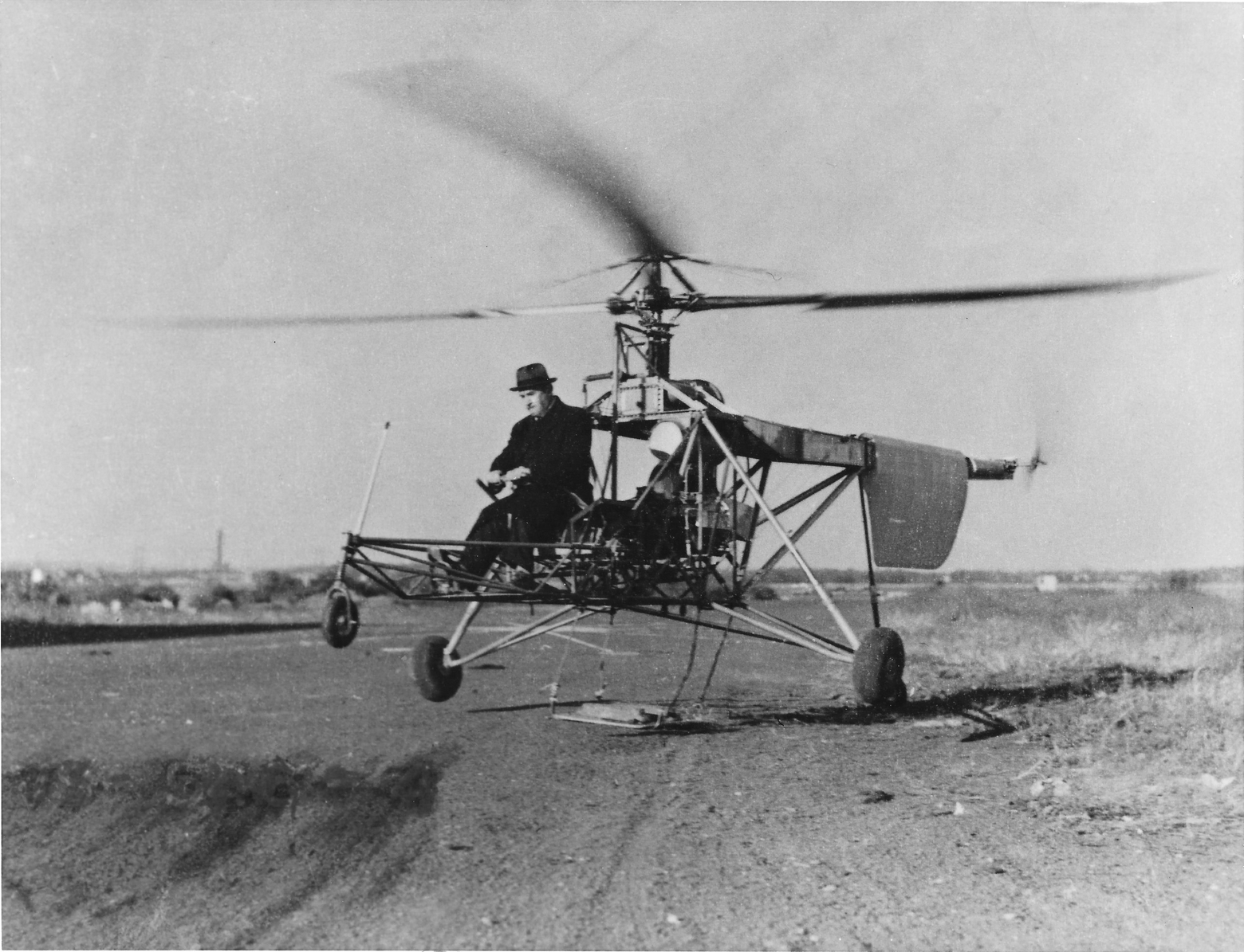 The prototype VS-300 helicopter clears the ground for the first time, 14 September 1939. Igor Sikorsky is at the controls. His right foot rests on the anti-torque pedal. (Sikorsky Historical Archives)