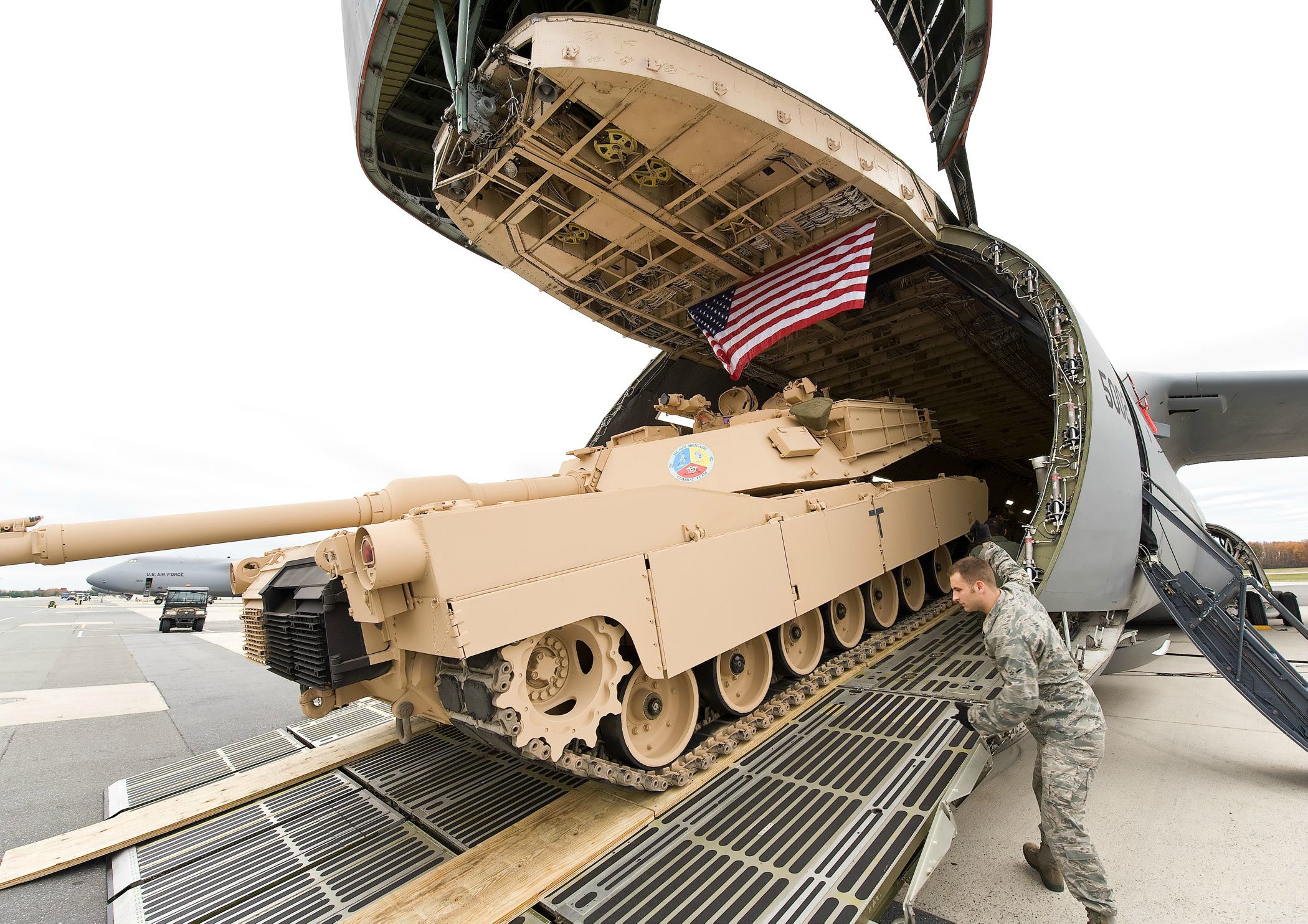 An M1 Abrams Main Battle Tank on the forward cargo ramp of a Lockheed C-5 Galaxy. The transports nose has been raised to provided loading access from the front of the airplane. (U.S. Air Force)