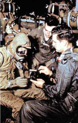 Marion Carl is dressing in teh Model 7 pressure suit aboard the P2BS-1 drop ship, 21 August 1953. (U.S. Navy)